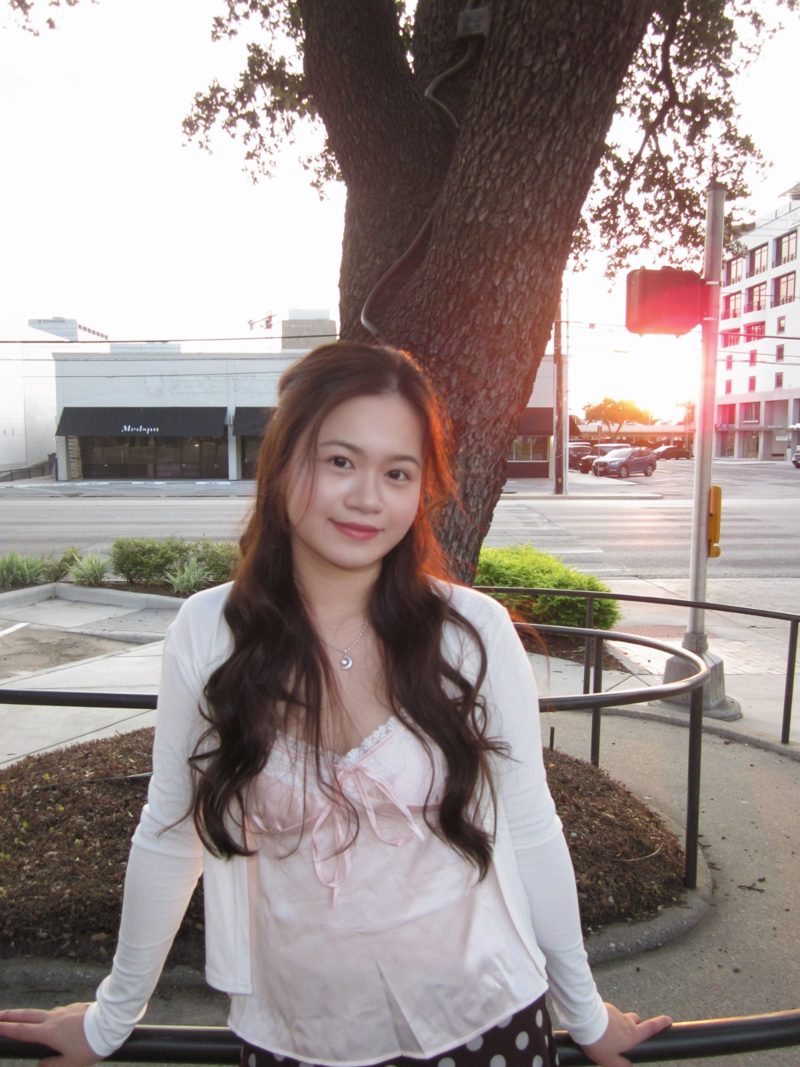 Anna smiling in a pink top at sunset